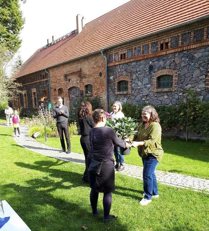 Gruppe von Menschen im Freien vor alten Gebäude